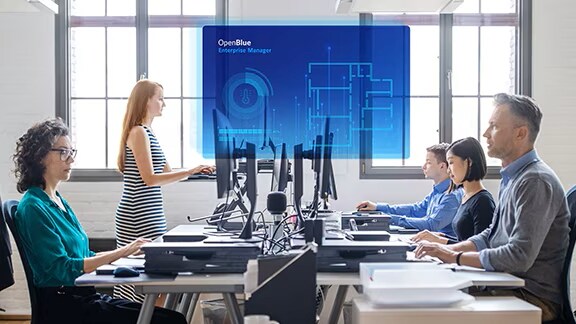 A group of people sitting at desks in an office